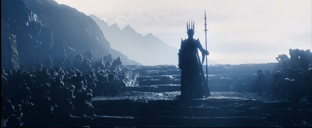 The Lord of the Rings: The Rings of Power- Sauron in his spiked armor standing over his Orc army. The Lord of the Rings: The Rings of Power- Sauron in his spiked armor standing over his Orc army.