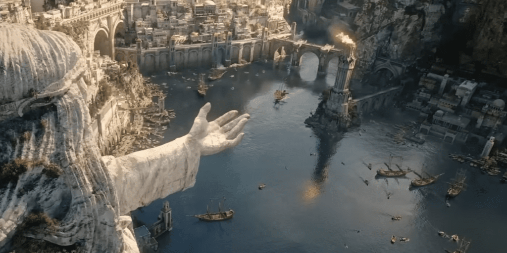 The Lord of the Rings: The Rings of Power- A harbor in Númenor with a flaming watch tower in the center. A statue with an outstretched hand looms over the left side.