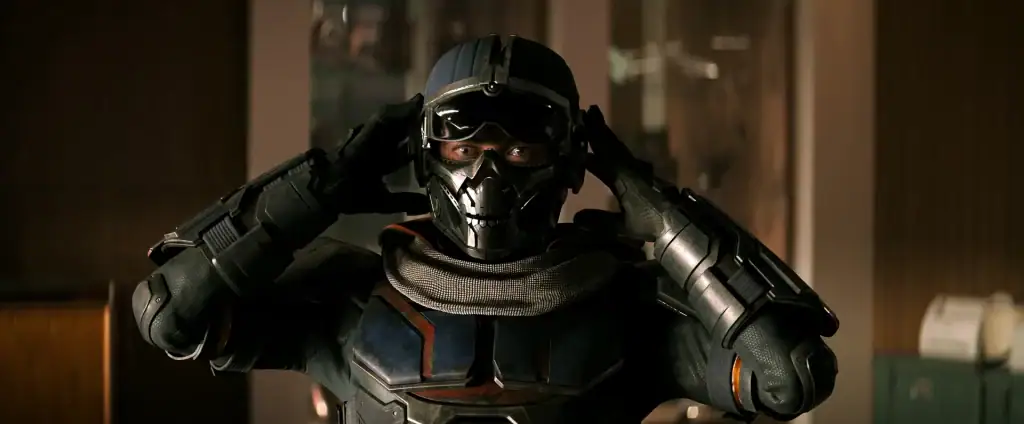 Taskmaster starting to remove her helmet in 'Black Widow'. Her eyes and mask are visible.