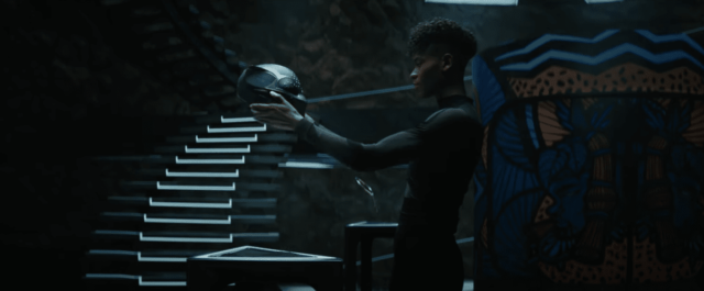 Shuri stares into the eyes of her own Black Panther mask